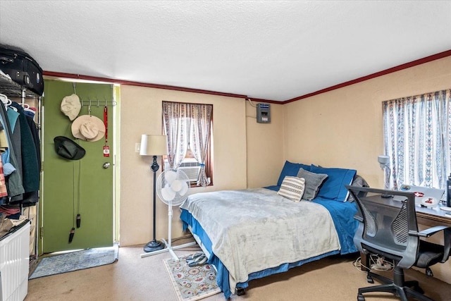 carpeted bedroom featuring ornamental molding and a textured ceiling