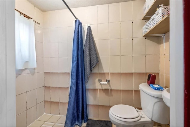 bathroom featuring tile walls, a shower with curtain, and toilet