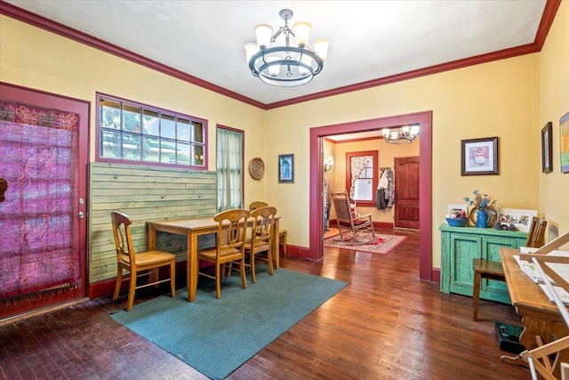 dining room featuring crown molding, dark wood-type flooring, and a chandelier