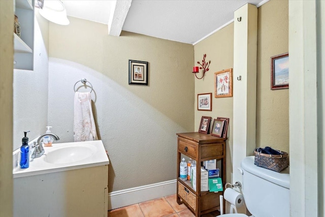 bathroom with tile patterned flooring, vanity, and toilet