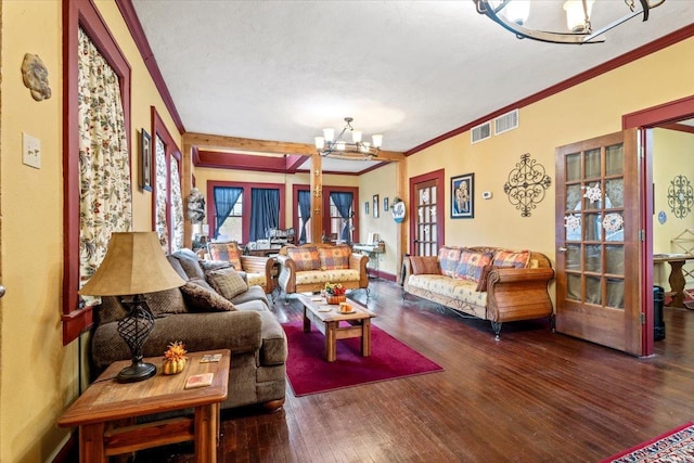 living room featuring hardwood / wood-style flooring, crown molding, and a notable chandelier