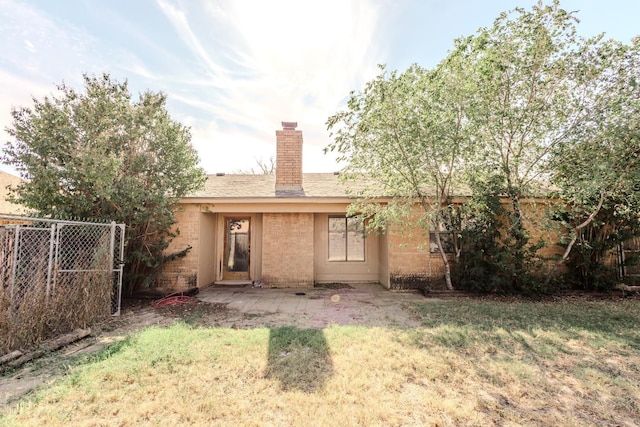 rear view of house with a yard