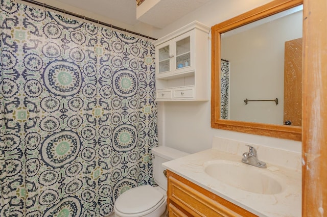 bathroom featuring vanity, a shower with shower curtain, and toilet