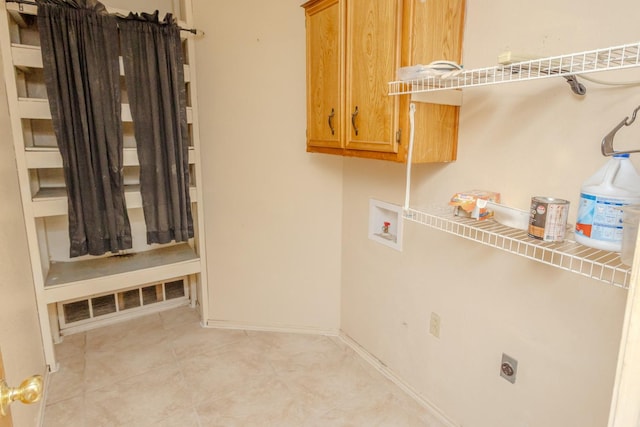 clothes washing area featuring cabinets, light tile patterned flooring, hookup for an electric dryer, and washer hookup