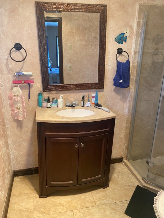 bathroom with a shower with door and vanity