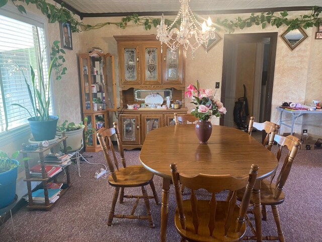 carpeted dining area with a notable chandelier and a wealth of natural light