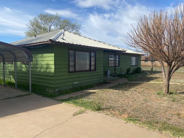 view of home's exterior featuring a carport