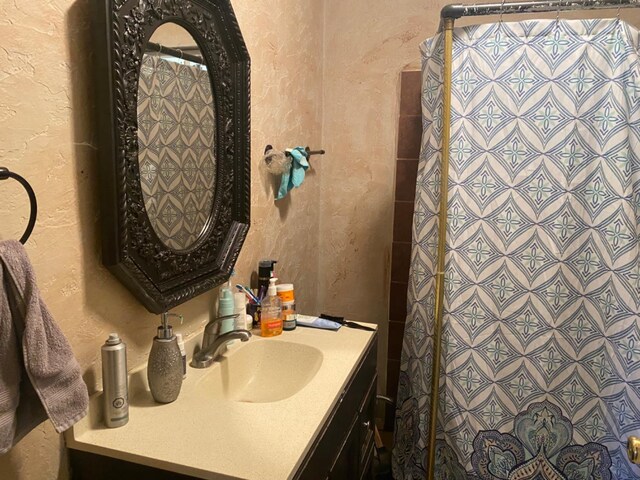 bathroom with vanity and a shower