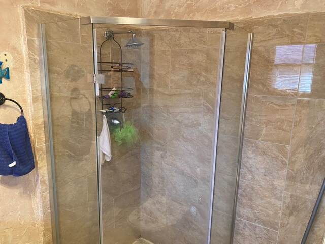 bathroom with tiled shower