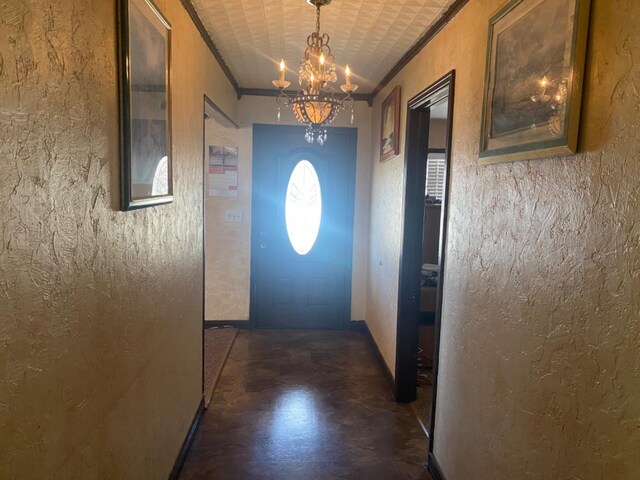 doorway with an inviting chandelier and crown molding