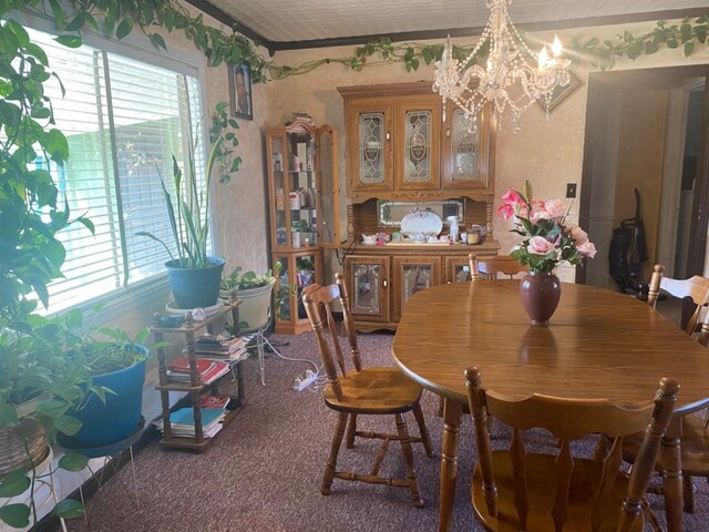 dining room with an inviting chandelier and plenty of natural light