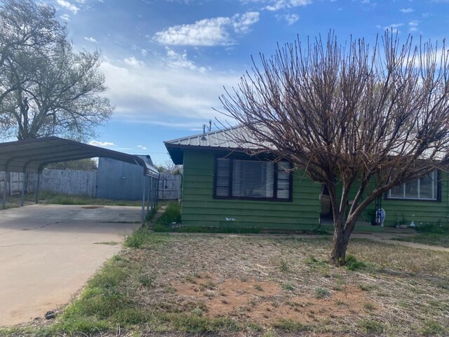 view of side of property featuring a carport