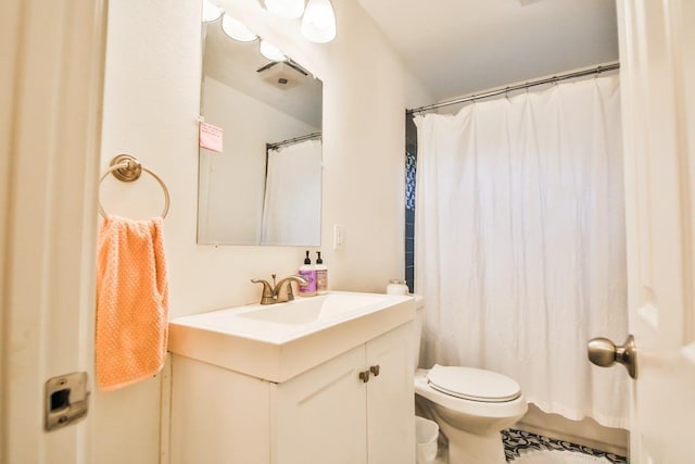 bathroom featuring vanity, a shower with shower curtain, and toilet