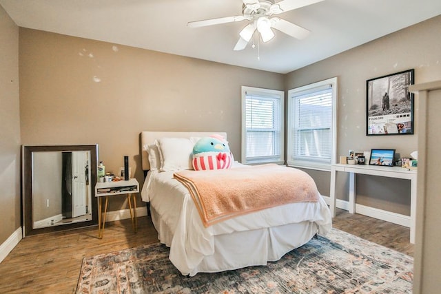 bedroom with dark hardwood / wood-style floors and ceiling fan