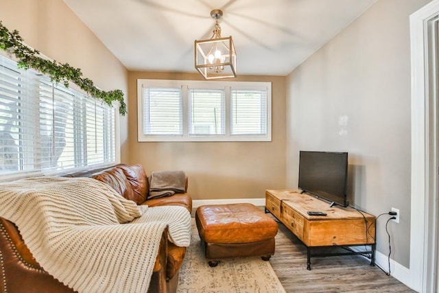 living room with hardwood / wood-style flooring, lofted ceiling, and plenty of natural light