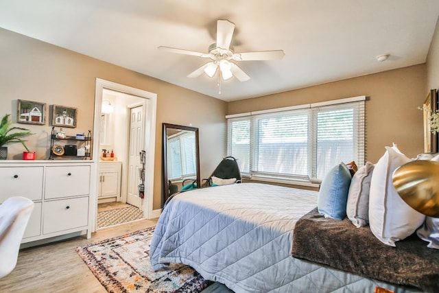 bedroom featuring connected bathroom, light hardwood / wood-style flooring, and ceiling fan