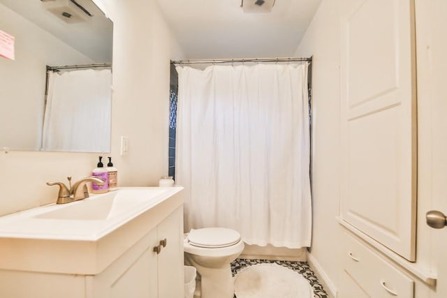 bathroom with vanity, walk in shower, and toilet