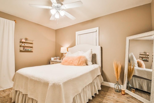 bedroom featuring hardwood / wood-style flooring and ceiling fan