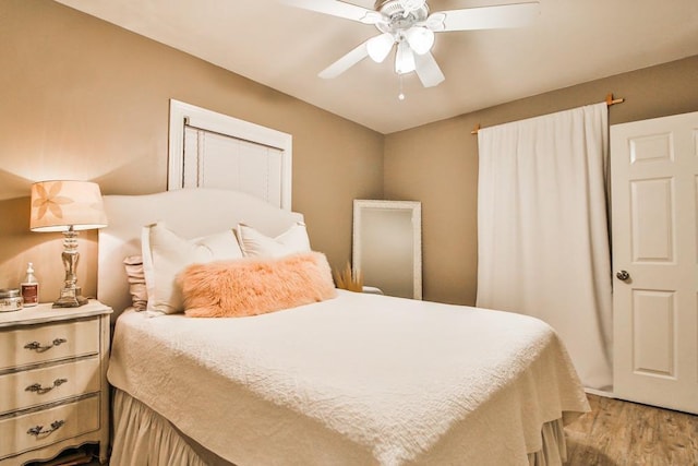 bedroom with light hardwood / wood-style flooring and ceiling fan