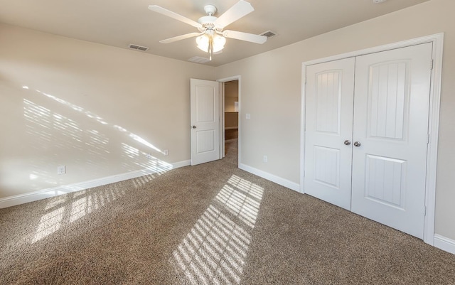 unfurnished bedroom featuring a closet, ceiling fan, and carpet