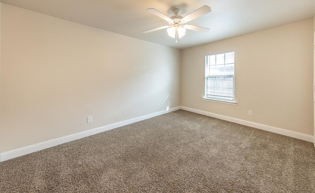 unfurnished room with ceiling fan and carpet