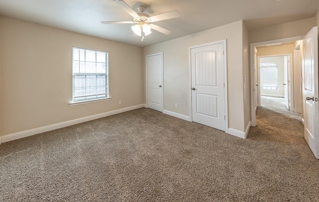 unfurnished bedroom with carpet flooring and ceiling fan