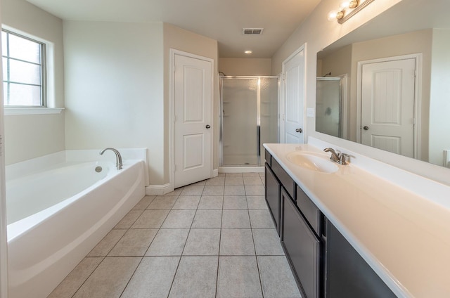 bathroom featuring tile patterned floors, separate shower and tub, and vanity