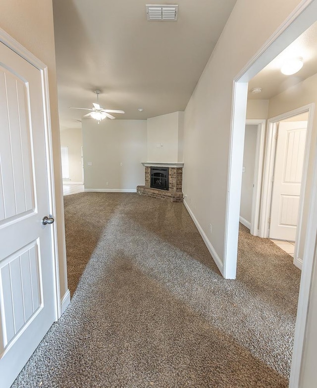 unfurnished living room with carpet floors and ceiling fan