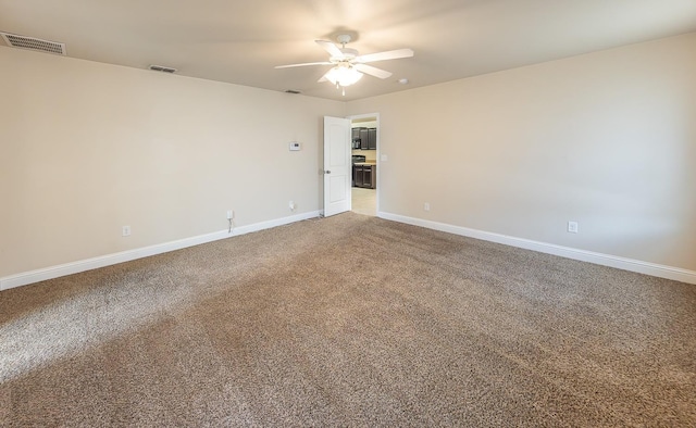 carpeted spare room with ceiling fan