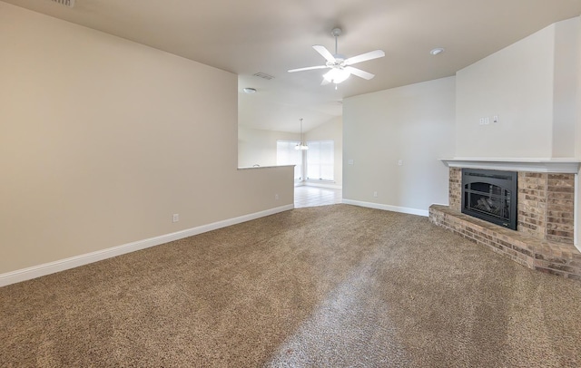 unfurnished living room with ceiling fan, lofted ceiling, carpet flooring, and a fireplace