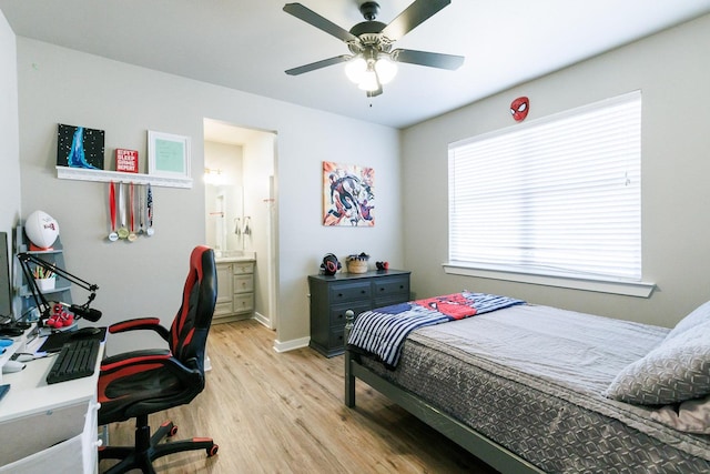 bedroom featuring ceiling fan, ensuite bath, and light hardwood / wood-style floors