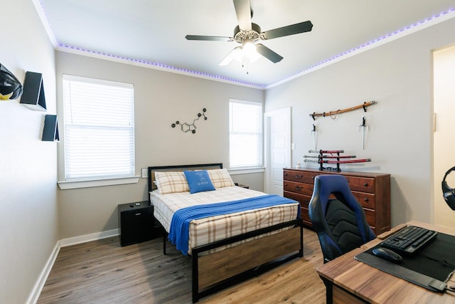 bedroom featuring ornamental molding, hardwood / wood-style floors, and ceiling fan