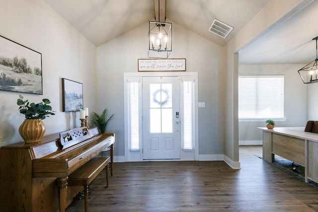 entrance foyer with a notable chandelier, dark hardwood / wood-style floors, and vaulted ceiling with beams