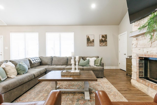 living room featuring hardwood / wood-style flooring and a fireplace