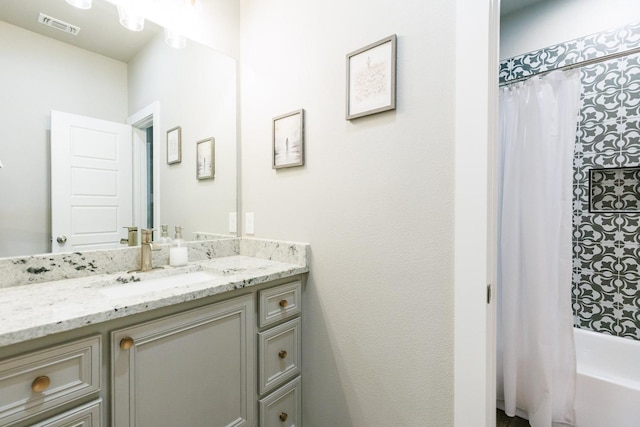 bathroom with vanity and shower / bath combo with shower curtain