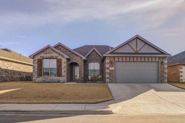 view of front of home with a garage and a front lawn