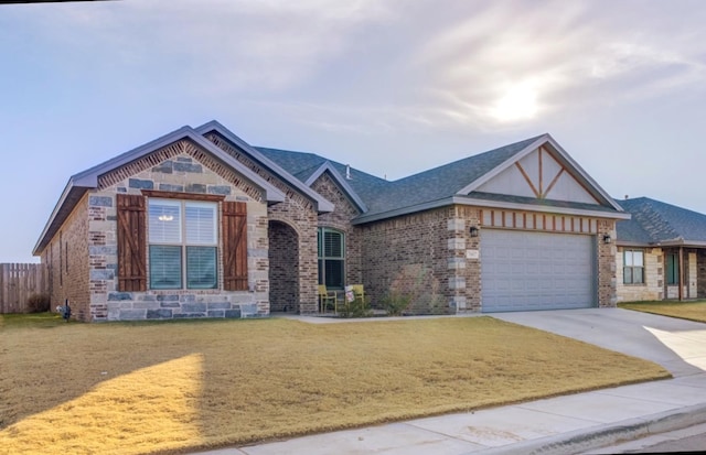 craftsman house featuring a garage and a front lawn