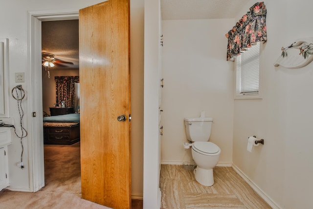 bathroom featuring ceiling fan and toilet