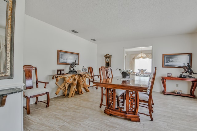 dining area with a textured ceiling