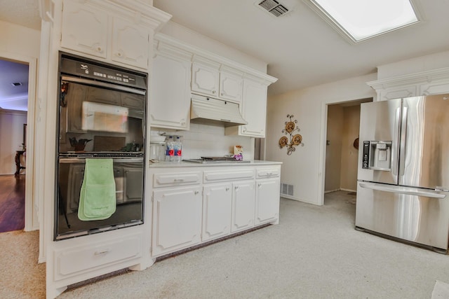 kitchen with appliances with stainless steel finishes, white cabinets, and decorative backsplash