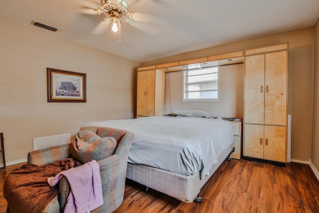 bedroom with dark wood-type flooring and ceiling fan