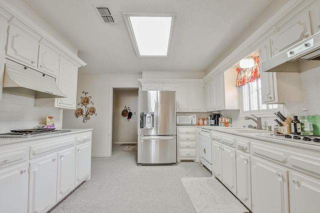 kitchen featuring appliances with stainless steel finishes, sink, and white cabinets