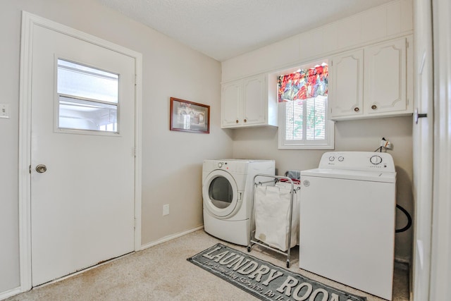 laundry area featuring cabinets and washing machine and clothes dryer