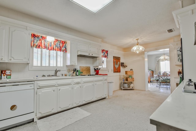 kitchen with pendant lighting, sink, white cabinets, a notable chandelier, and white dishwasher