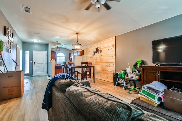 living area with wood finished floors, ceiling fan, and visible vents