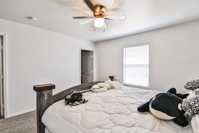 carpeted bedroom with baseboards and ceiling fan