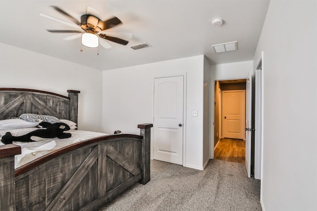 bedroom with light colored carpet, visible vents, a ceiling fan, and baseboards
