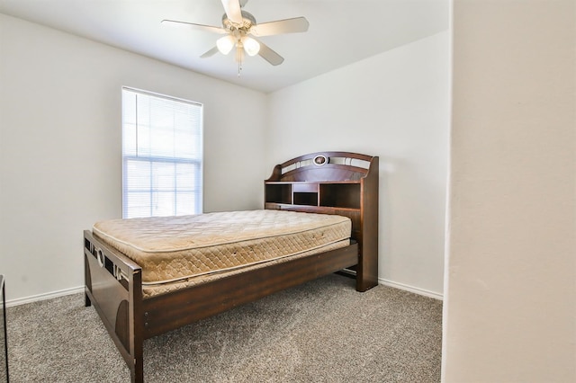 bedroom with a ceiling fan, carpet flooring, and baseboards