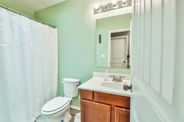 bathroom featuring vanity, toilet, and a shower with shower curtain