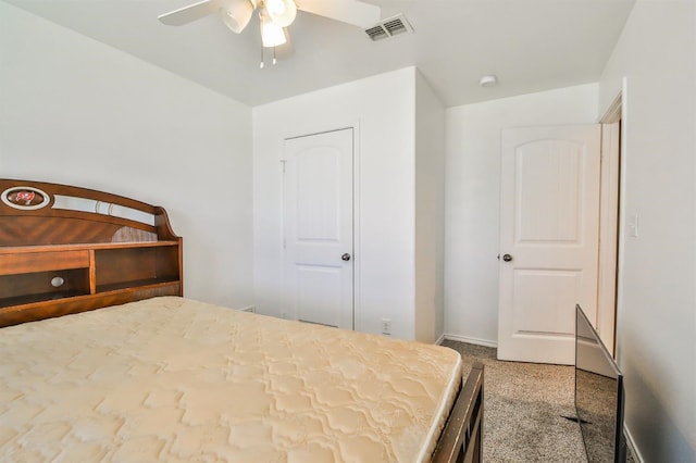 bedroom featuring baseboards, visible vents, a ceiling fan, and carpet